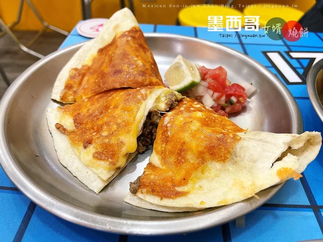 👩🏻‍🌾 新北汐止｜我行我素南洋健康蔬食
...
吃到甜甜價 Taco 塔可、Quesadilla 起司餡餅真開心，當然台式鹹豆漿的味道也很棒！路透社消息，這裏的爆漿半熟起司蛋飯糰也是人氣必點，還有墨西哥辣豬煎包、墨西哥捲餅 Burrito 這些二訪都想吃。等待機會到墨西哥之前，先透過美食與墨西哥連結吧！
⋯
🌟 鹹豆漿 40TWD
🌟 TACO 起司蛋餅 80TWD
🌟 TACO 燒餅 95TWD
🌟 墨西哥起司餅 110TWD
... 
🎯 墨西哥女婿燒餅店
🏠 台北市松山區新東街6巷2號
 📞 0920-337-363
⏰ 週三至週一 1000-1400 & 1700-2030（週二休）
🚇 民生社區中心，500m腳程約8分鐘
🛵 ubereats、foonpanda
... 
📍 台灣>台北市>松山區>墨西哥女婿燒餅店 Mexican Son-in-law Shao Bing, Songshan, Taipei City, Taiwan
🌯 台墨手作餅包餡好吃→https://jingxuan.tw/mexican-son-in-law-shao-bing/
🧭 部落格→https://jingxuan.tw/ 
🌹 請移至此IG個人資料，點選Blog連結即可閱讀更多圖文，謝謝！Tap on the link in this bio/profile to read more. Thx! 
⋯
#墨西哥女婿燒餅店  #台墨手作餅 #鹹豆漿 #塔可 #燒餅 #黑豬肉 #煎包 #TACO #Quesadilla #莎莎醬 #民生社區美食 #MexicanSoninlawShaoBing #Burrito #SavorySoyMilk #MexicanCuisine #FoodinTaipei #TraveltoTaipei #Holiday #follow4follow #like4like #likeforlike #igdaily #travel #vacation #Jingxuan時空旅人 #JingxuanJing #picoftheday #instalikes